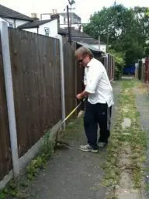 Cllr Nigel Clarke gets to work with the strimmer