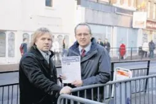 STRUGGLING BUSINESS?: Councillor David Kendall passes a survey to Hair Company owner Nigel Clarke. Picture by Martin Dalton