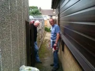 AFTER: Cllr Barry Aspinell and Cllr David Kendall leave the garden fit to enjoy for a disabled couple in Pilgrims Hatch