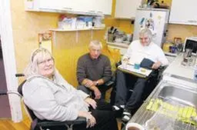 Cllr Barry Aspinell with the Tuckers in their home